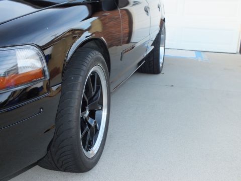 2003 Ford Crown Victoria - A black 2003 Ford Crown Victoria is shown from the side, aftermarket wheels and tires.
