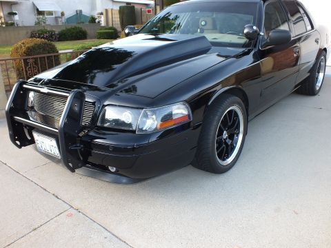 2003 Ford Crown Victoria - This 2003 Ford Crown Victoria features a prominent hood scoop and a sturdy push bar on the front.