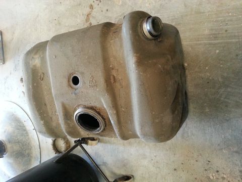 1994 Ford Bronco - A tan fuel tank is shown from an overhead perspective, with visible markings and a metal cap.