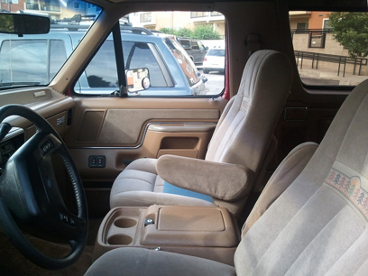 1988 Ford Bronco - The interior of a 1987 Ford Bronco is visible, with other vehicles parked outside.