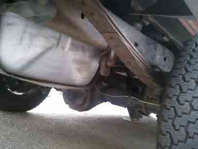 1988 Ford Bronco - Undercarriage view showing the fuel tank and suspension components of a vehicle.