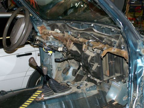 1988 Suzuki Samurai - Vehicle interior disassembled, exposing the steering column and dashboard components.