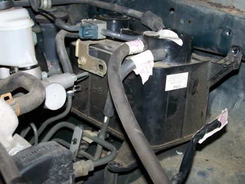 1988 Suzuki Samurai - Engine bay components, including a Toyota-branded reservoir, are visible in this close-up view.