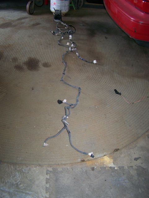 1988 Suzuki Samurai - A complex wiring harness is spread across the floor, likely for a vehicle repair or modification.