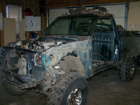 1988 Suzuki Samurai - This heavily modified pickup truck is missing its front fenders and hood, revealing the engine bay.