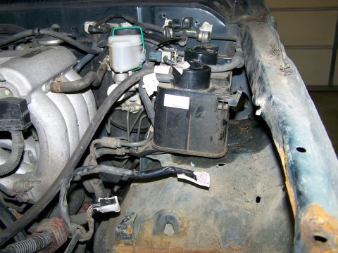 1988 Suzuki Samurai - Close-up view of the engine bay, showing the brake fluid reservoir and intake manifold components.