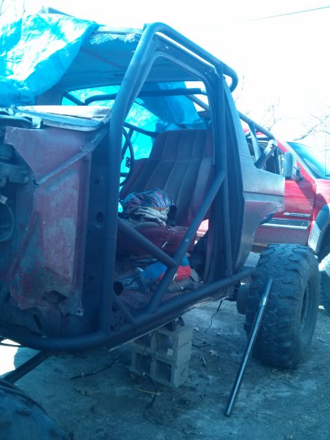 1986 Ford Bronco - This heavily modified vehicle features an exposed interior with a roll cage and oversized off-road tires.