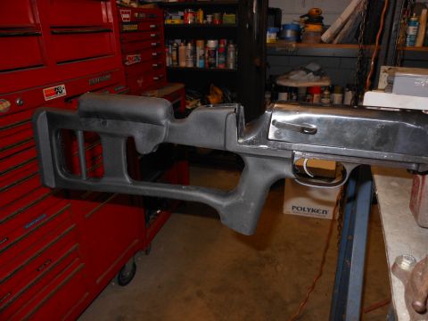 1978 Ford F-250 - A gun receiver and stock are shown in a workshop setting, with a red toolbox in the background.