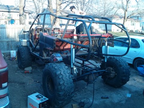 1986 Ford Bronco - This custom off-road buggy, possibly a modified Ford Bronco, is seen in a state of construction with its frame and large tires visible.