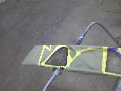 2003 Ford Crown Victoria - A car grille and headlight assembly is covered with masking tape and a protective sheet.