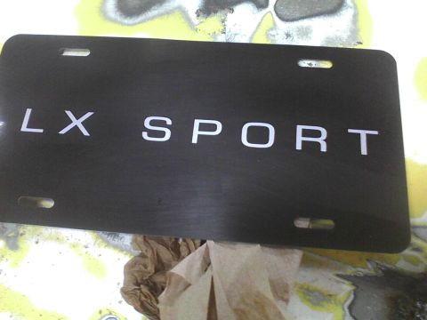 2003 Ford Crown Victoria - A black license plate frame displays 'LX SPORT' in white lettering against a brushed metal background.