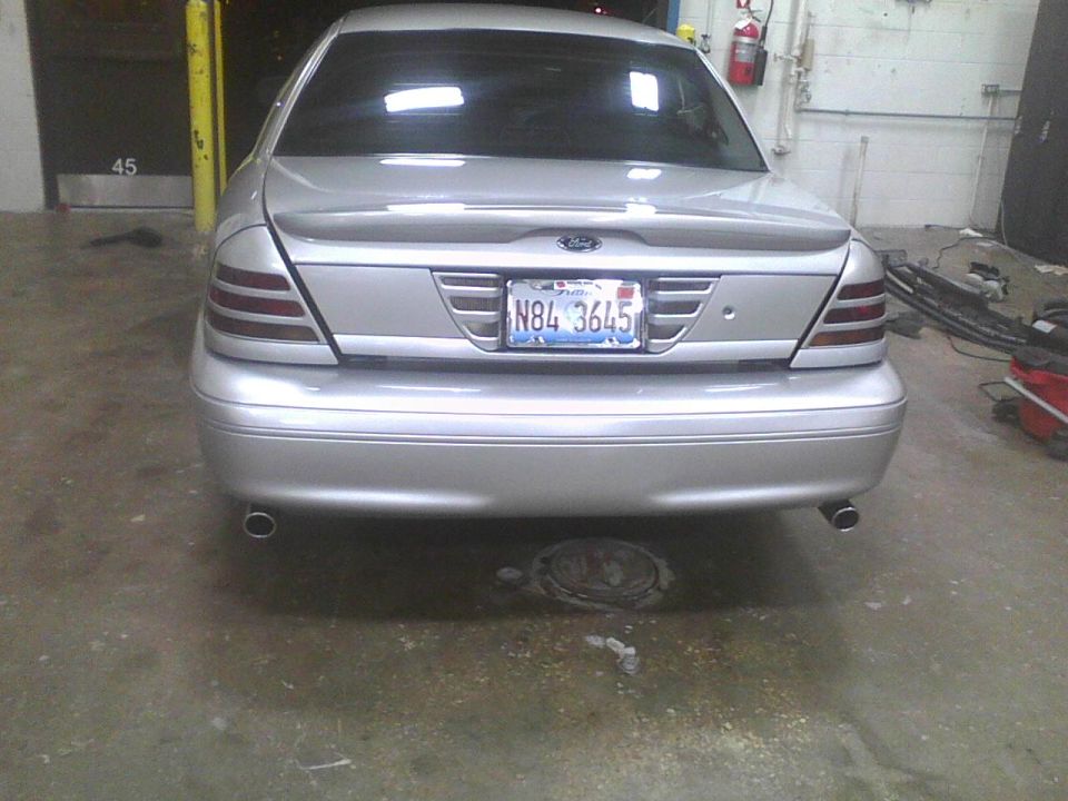 Silver 2003 Ford Crown Victoria rear view with license plate N84 3645