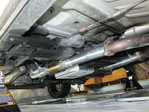 2003 Ford Crown Victoria - Polished stainless muffler and catalytic converter routed along the underbody of a raised vehicle.