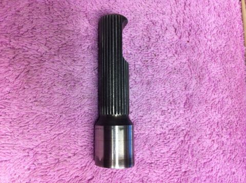 1987 Suzuki Samurai - A metal splined shaft with a distinctive cut-out is shown against a textured pink background.