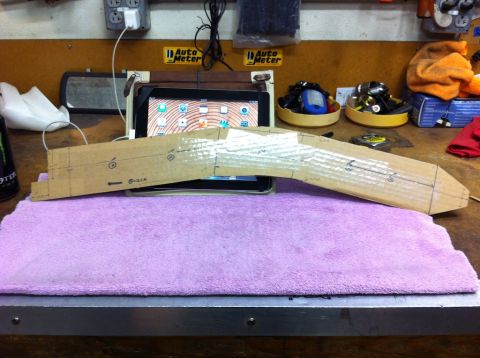 1987 Suzuki Samurai - A cardboard template with markings is placed on a purple towel on a workbench.