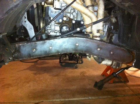 1987 Suzuki Samurai - Close-up view of vehicle's front axle and suspension system, showing custom fabrication and a date stamp on a component.