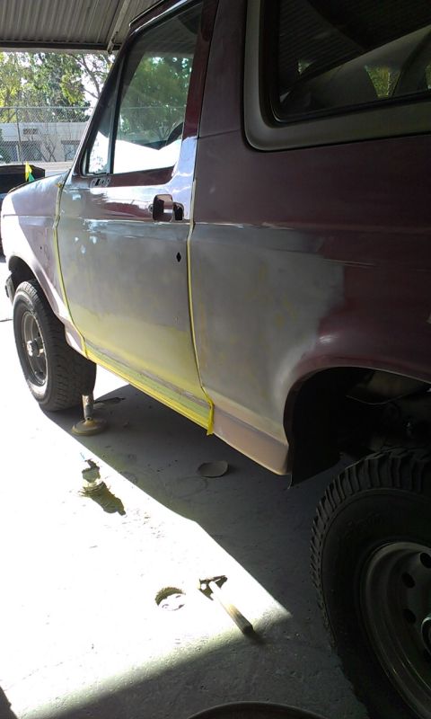 1994 Ford Bronco - The vehicle is in a garage, with tools and supplies scattered around the floor.