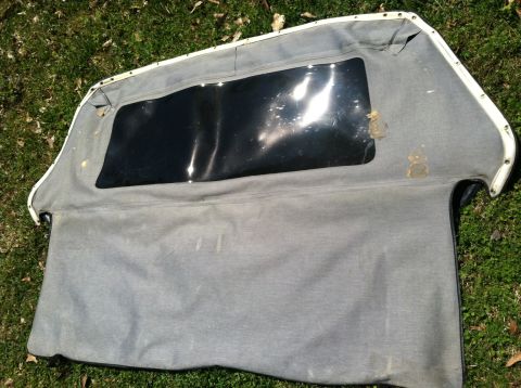1990 Ford Bronco - This is a soft top for a vehicle, shown laid out on a grassy surface.