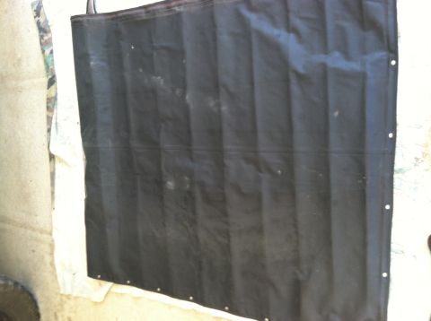 1990 Ford Bronco - A black fabric part, possibly a cover or curtain, is shown with grommets along its edge.