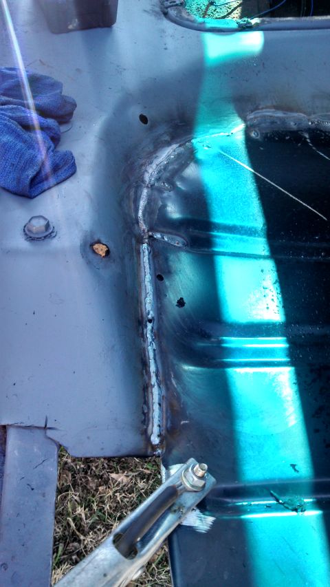 1979 Ford Bronco - Close-up of a welded metal panel, showing repair work and a blue cloth.