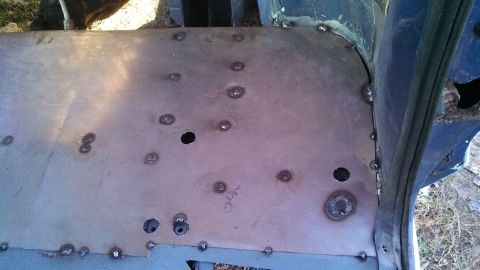 1979 Ford Bronco - A metal floor panel has been welded into place, showing numerous spot welds and some drilled holes.