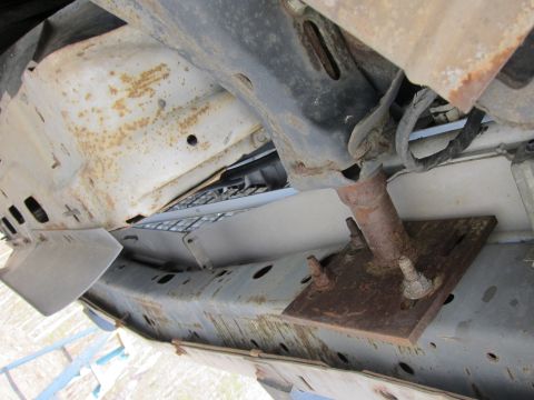 1991 Ford LTD Crown Victoria - Close-up of the undercarriage, showing significant rust on the frame and suspension parts.