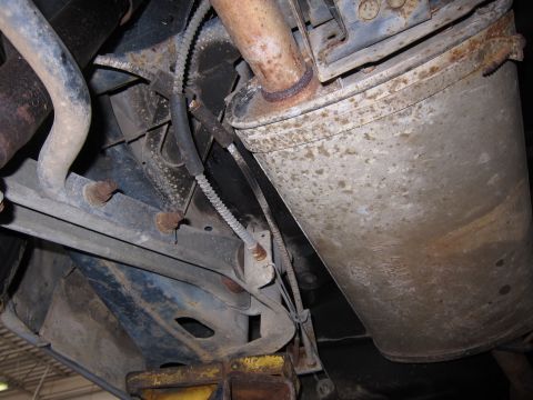 1991 Ford LTD Crown Victoria - The rusty exhaust system of a vehicle is shown from below, with various suspension components visible.