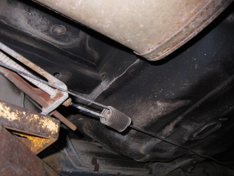 1991 Ford LTD Crown Victoria - Underside view of a vehicle's exhaust system and brake cables.