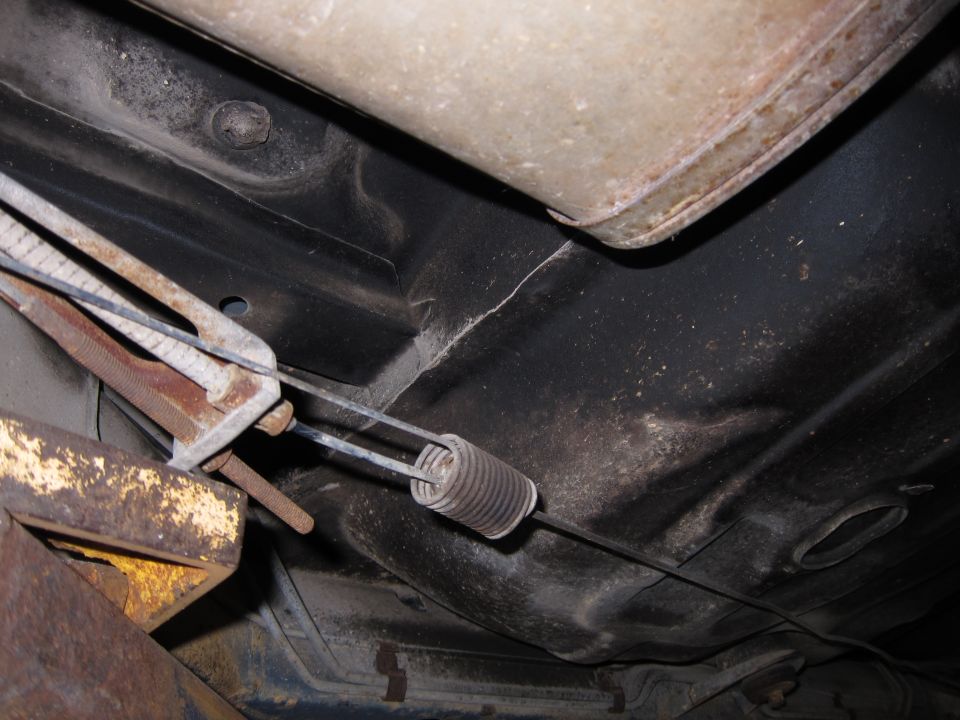 Vehicle underbody with exhaust pipe and brake cable