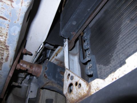1991 Ford LTD Crown Victoria - Detail view of a car's radiator and surrounding structural elements, showing signs of rust.
