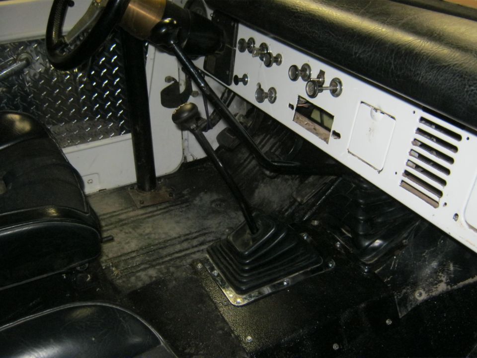 1970 Ford Bronco interior showing dashboard, steering wheel, shifter, and seats