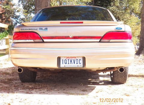 1993 Ford Crown Victoria - Rear view of a tan Ford Crown Victoria showing its taillights and license plate.