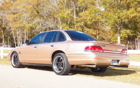 1993 Ford Crown Victoria - This Ford Crown Victoria has a distinctive rear spoiler and dual exhaust pipes, suggesting a performance modification.
