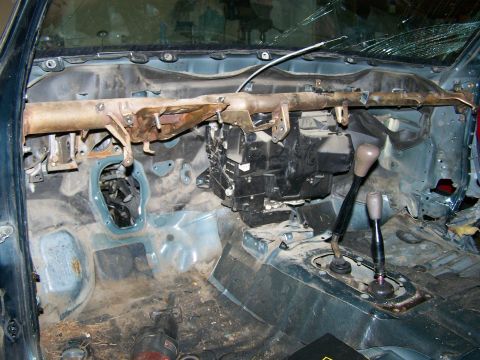 1988 Suzuki Samurai - Interior of a vehicle stripped down to the metal, with exposed dashboard and floor components.