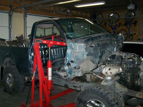 1988 Suzuki Samurai - Truck chassis undergoing repair or modification in a garage setting.