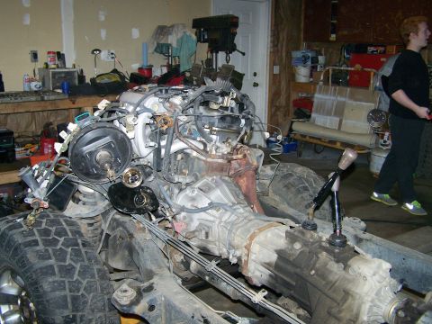1988 Suzuki Samurai - A vehicle chassis is shown with its engine and transmission removed, revealing the bare frame and suspension.