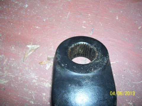 1990 Ford Bronco - A close-up view of a splined metal part, likely a component for a vehicle, is shown against a textured background.