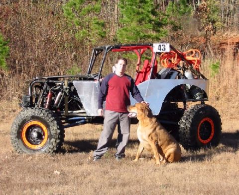 1994 Ford Bronco - A custom-built off-road buggy is shown with a person and a dog posing in front of it.