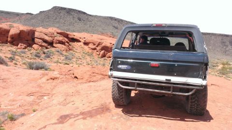 1994 Ford Bronco - This 1994 Ford Bronco is navigating a , red rock landscape under a clear sky.