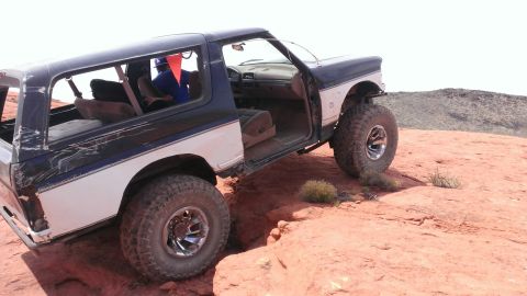 1994 Ford Bronco - This lifted 1994 Ford Bronco navigates challenging rocky terrain with its doors open.