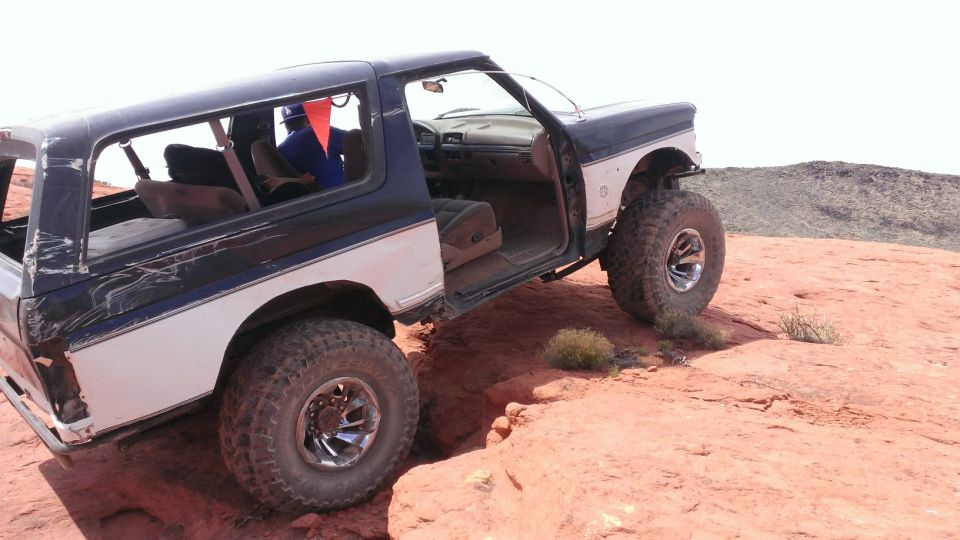 1994 Ford Bronco, doors open, on rocky terrain