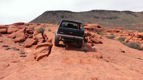 1994 Ford Bronco - This SUV is navigating a rocky, desert terrain.
