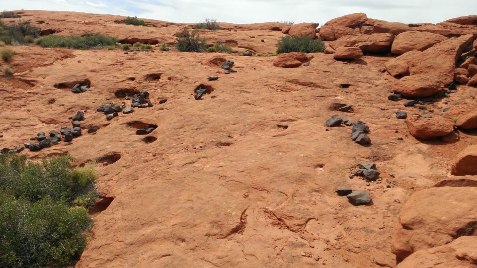 Rocky desert landscape with sparse vegetation and a Supermotors watermark