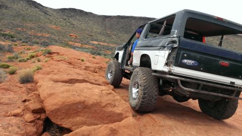 1994 Ford Bronco - This modified Ford Bronco navigates a rocky trail in a desert landscape.