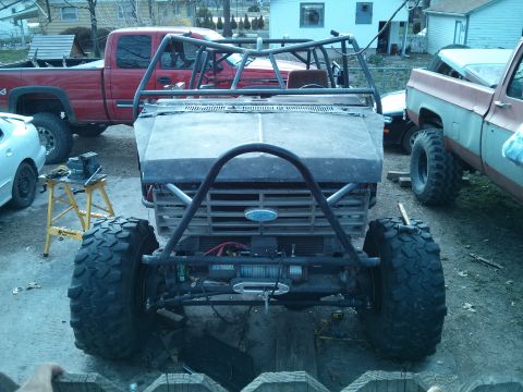 1986 Ford Bronco - This heavily modified vehicle appears to be an older Ford, possibly from the 1980s, with extensive off-road modifications.