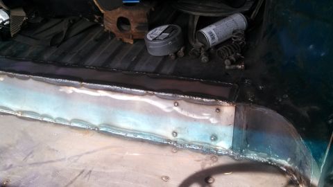 1979 Ford Bronco - The interior floor of a vehicle shows recent welding and repair work, with various tools scattered around.