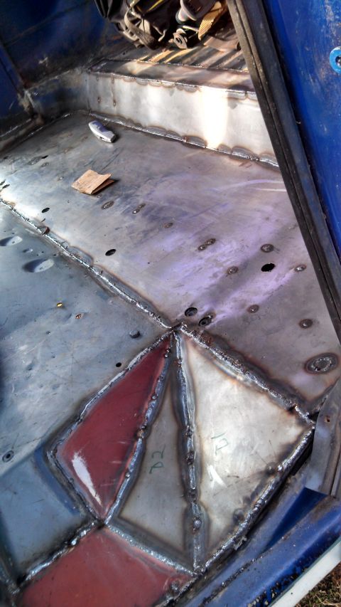 1979 Ford Bronco - The floor of this vehicle has been repaired with welded metal plates, some painted red.