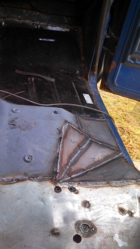 1979 Ford Bronco - The interior floor pan shows extensive welding work, indicating repairs or modifications.