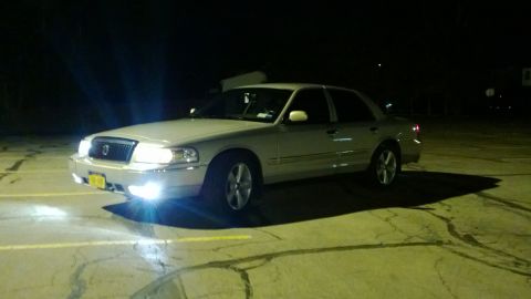 2008 Mercury Grand Marquis - A silver 2008 Mercury Grand Marquis is shown parked at night with its headlights illuminated.