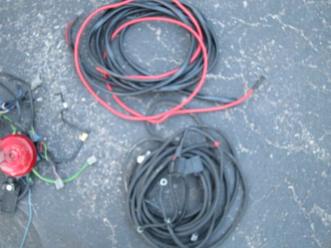 1991 Ford LTD Crown Victoria - Automotive wiring harnesses are coiled on a dark, textured surface.